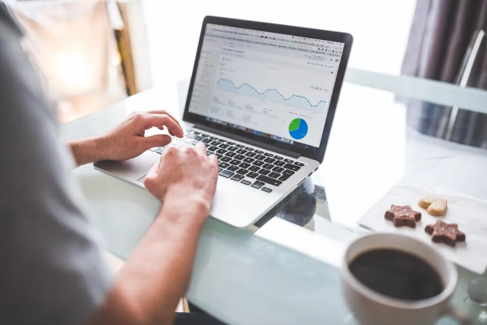 Business owner reviewing analytics charts and budget numbers at a desk